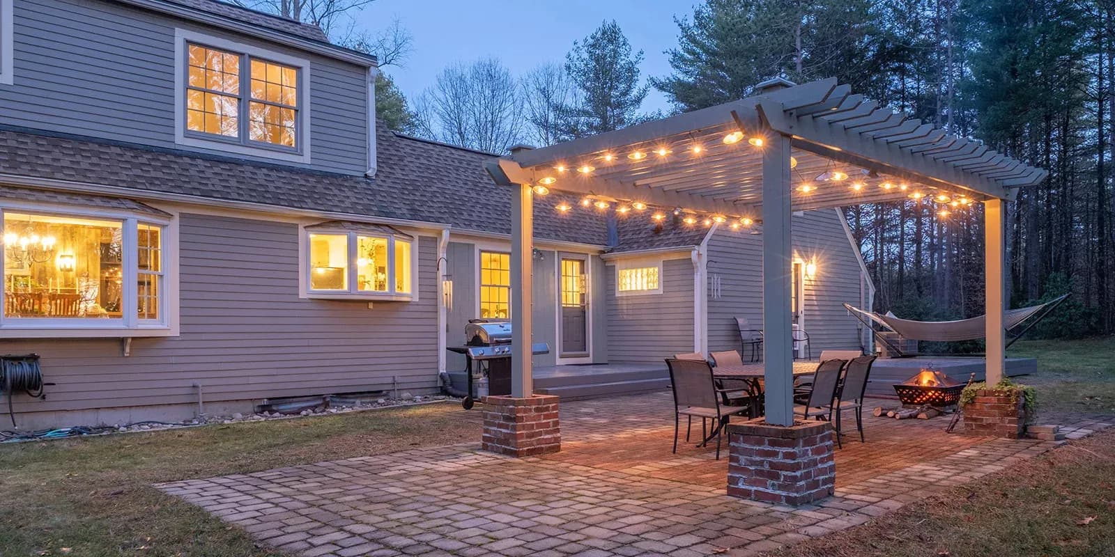 House with outdoor pergola covered in lights